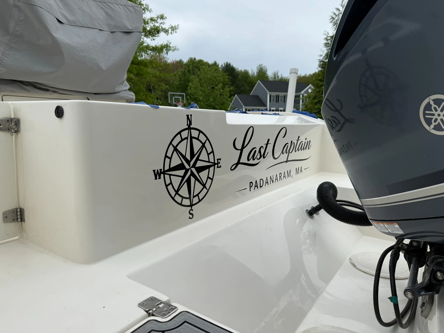 Last Captain name and compass rose decal on the boat transom